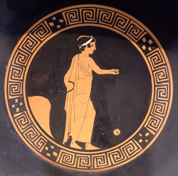 Photograph of Greek vase with image of a boy playing with yo-yo, circa 440 BC. Photo courtesy of Wikimedia Commons user Bibi Saint-Pol through Creative Commons License Attribution.