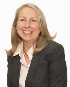 Headshot of a smiling blonde woman in a business suit