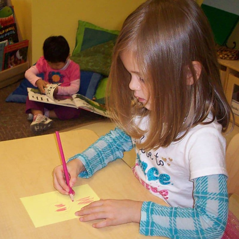 Girl coloring in classroom