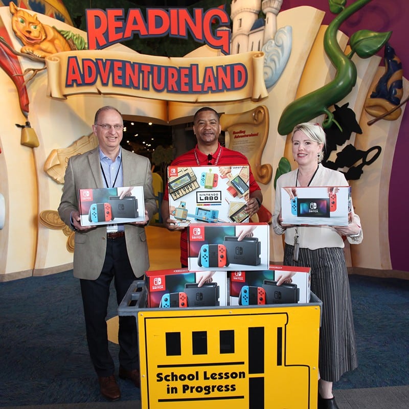 Staff and community presenting Nintendo switch donation