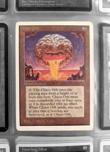 The card Chaos Orb in a sleeved binder of Magic: The Gathering cards from the personal collection of game designer Arnold Hendrick; The Strong, Rochester, New York.