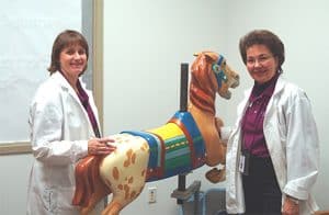 Chris Wenderlich and Sue Dowling show a carousel horse, The Strong, Rochester, New York