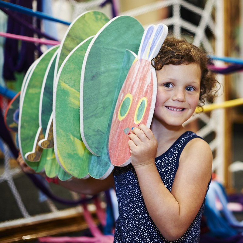 girl holding hungry caterpillar