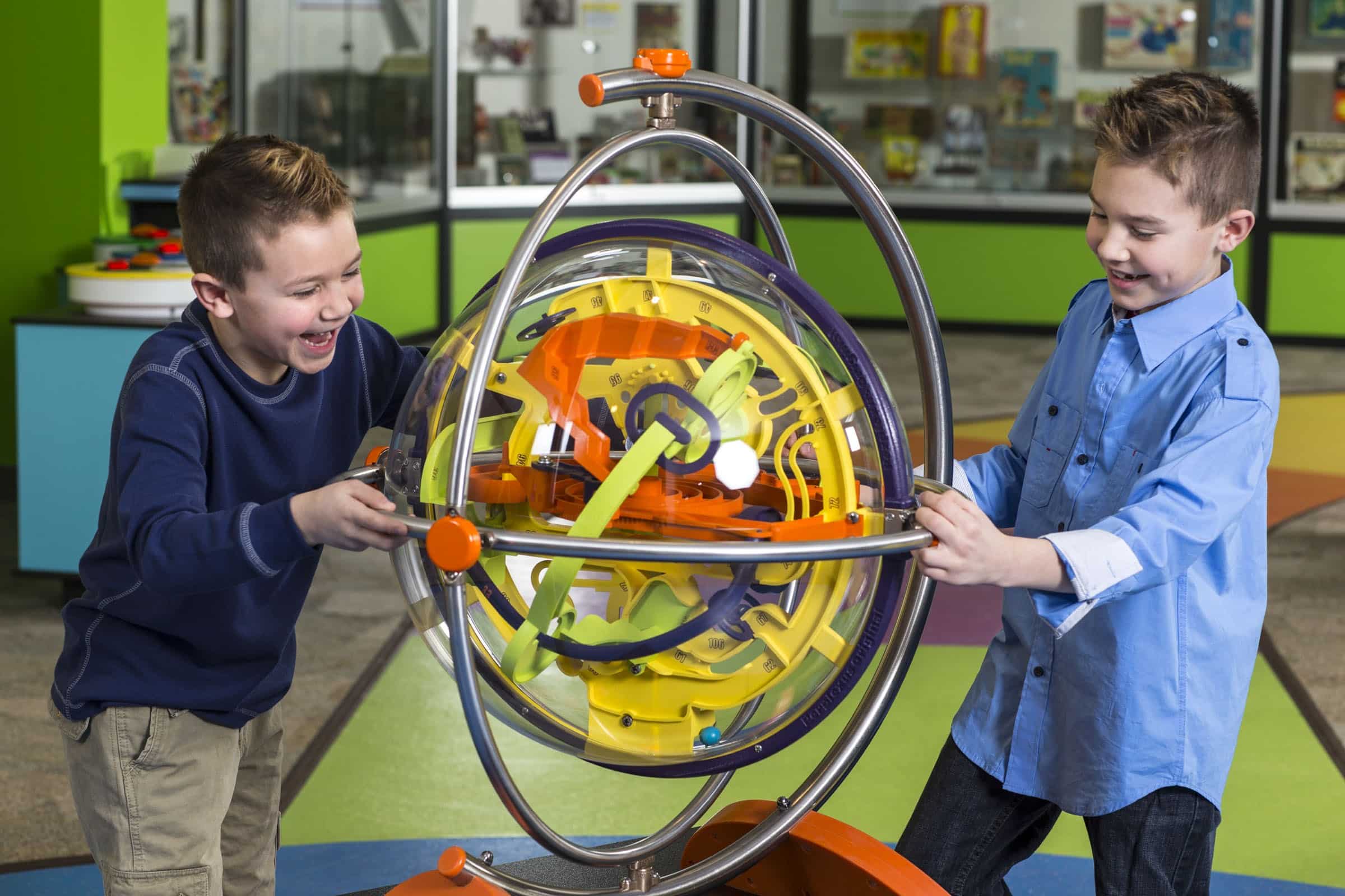 Boys playing perplexus puzzle