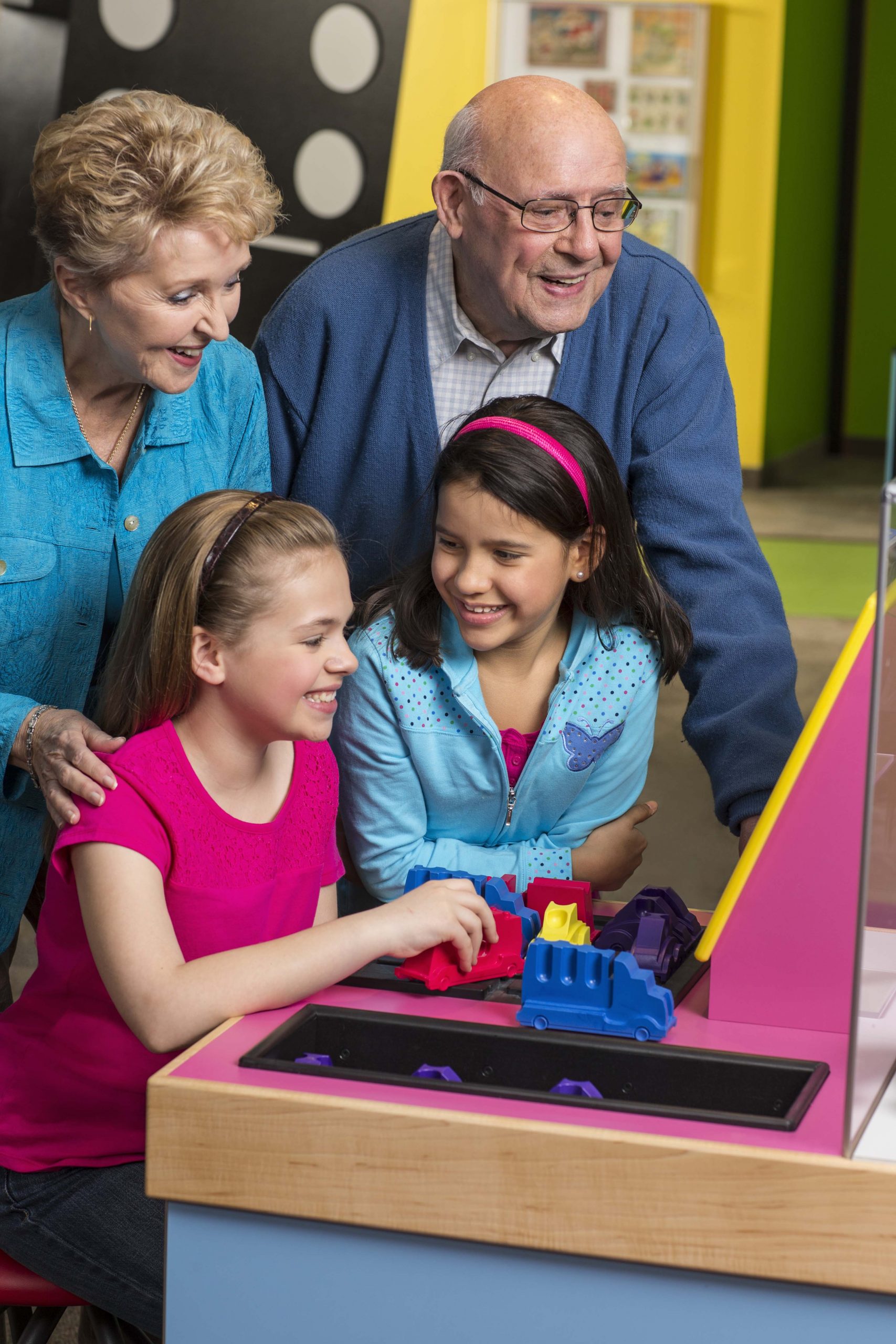 Grandparents and grandkids in Game Time exhibit