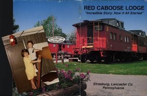 Julia and Bobby Novakovic at the Red Caboose Motel, 1993, with Red Caboose Lodge souvenir booklet, n.d. Courtesy of Bill Novakovic.