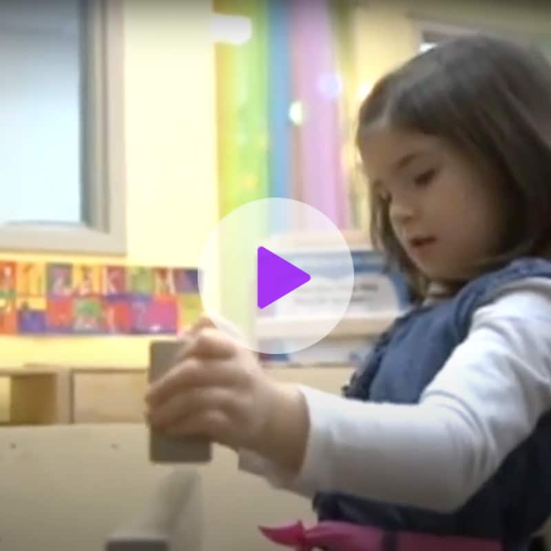 Screen shot of Woodbury video with child playing blocks