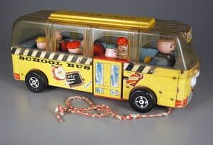 The Fisher-Price Safety School Bus featured the first removable Little People. This version of the pull toy dates from about 1961. The Strong, Rochester, New York.