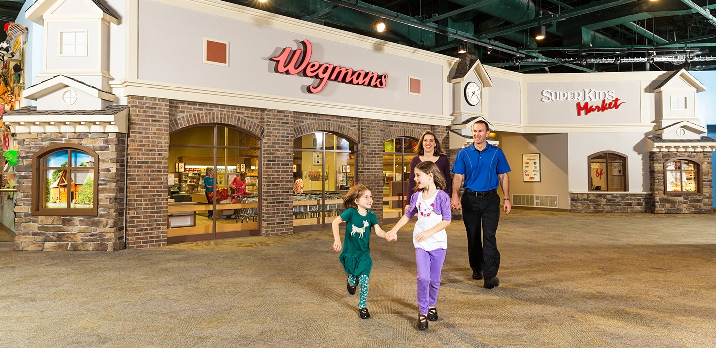 Family walking outside Wegmans super kids market