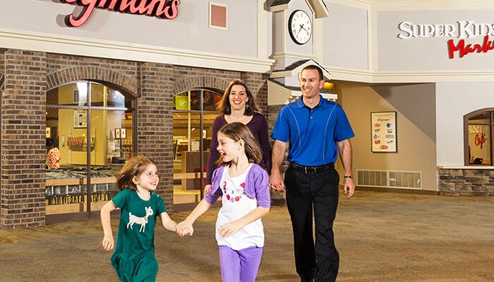 Family outside of Wegmans super kids market