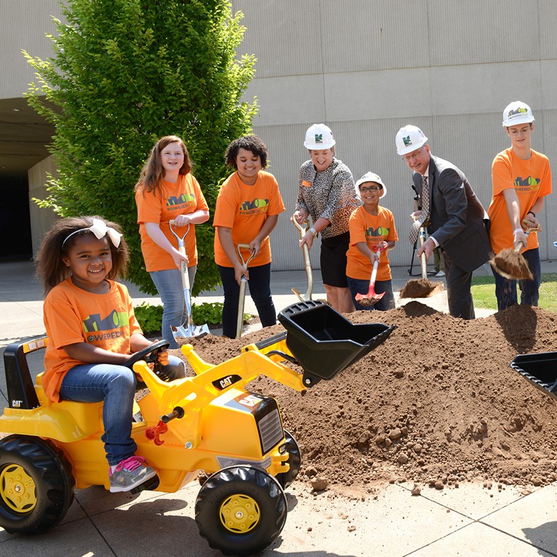 Groundbreaking ceremony shoveling dirt with kids