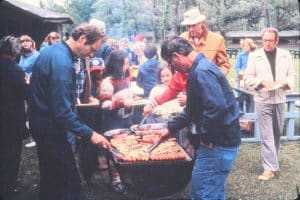 The Lutheran Church of the Incarnate Word in Rochester sponsors yearly picnics at various local parks. Church members are grilling in this photograph from June 1980. A role often taken by men, the barbecue grill-master is an important one at such functions.Photograph, Gift of William J. Tribelhorn, The Strong, Rochester, New York