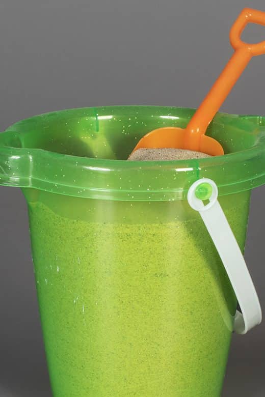 plastic bucket of sand with shovel