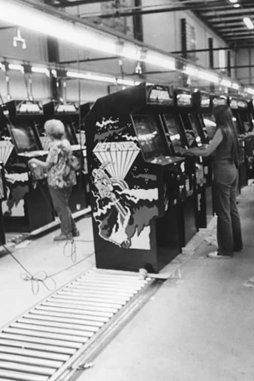 Women testing arcade machines