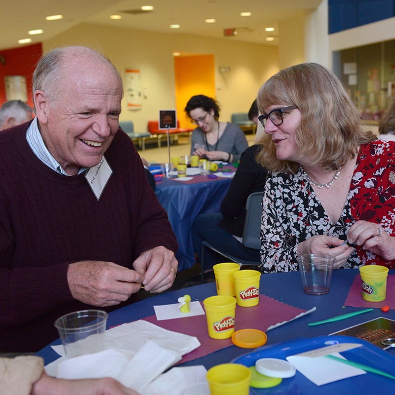 Museum secrets couple playing with play doh