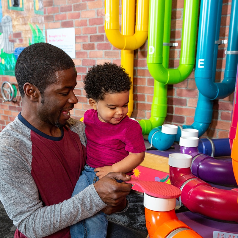 Dad and son in Sesame Street playground