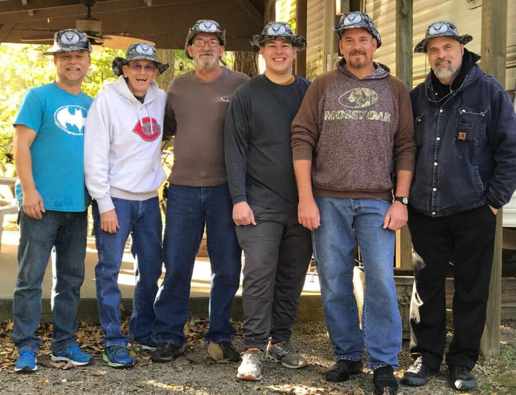 Digital photograph of John Crocker and his Gulf War Air Force Squad, about 2019, The Strong, Rochester, New York. Gift of John Crocker. Their “official” Risk insignia patch is seen on their hats.