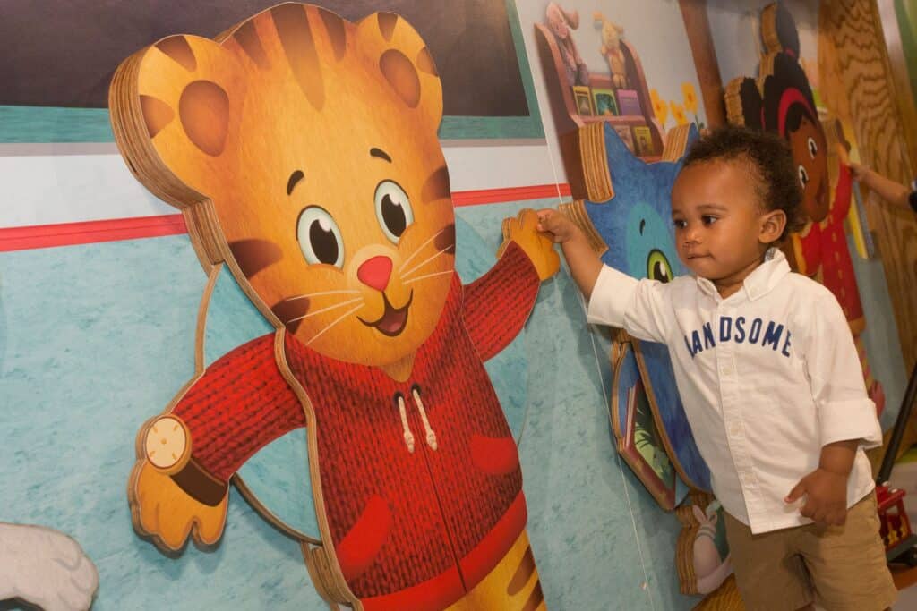 Boy and Daniel Tiger high-five