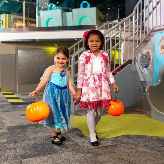 Toddlers trick or treating in museum