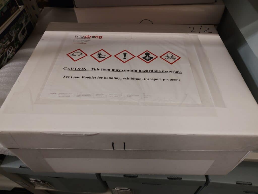 Image of Warning label applied to a box in storage.