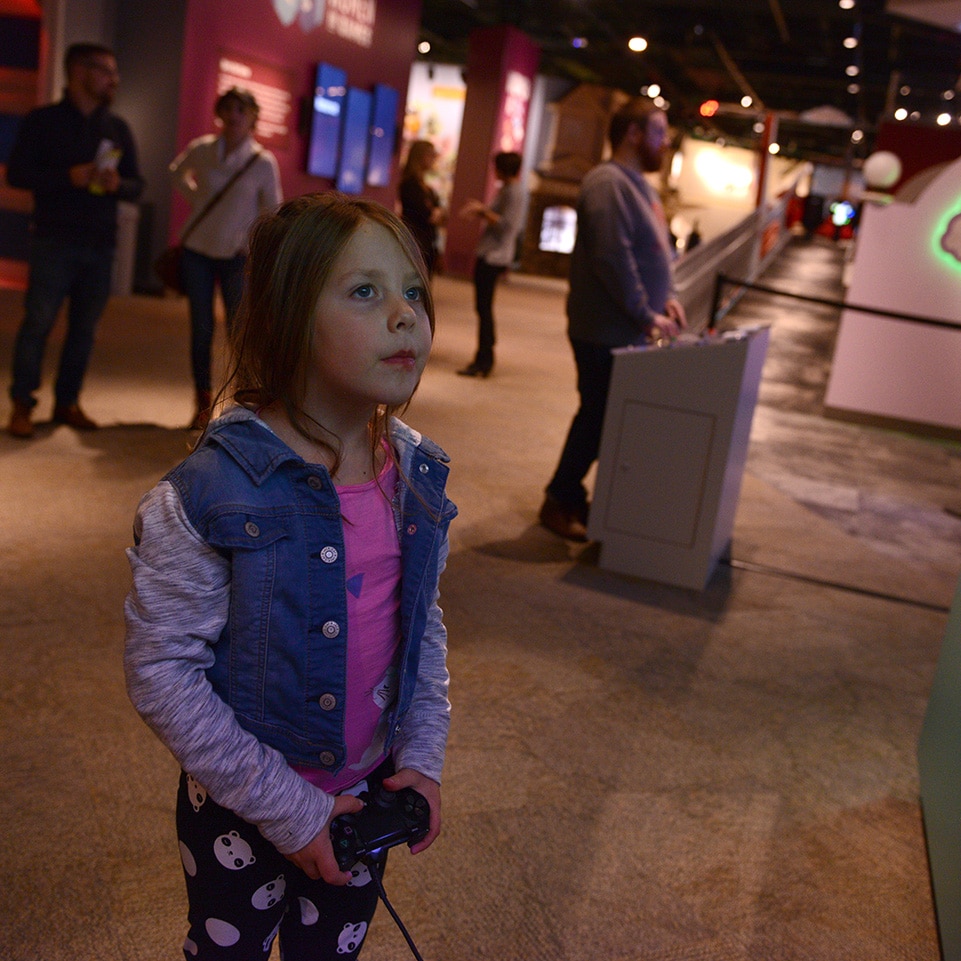 Girl in Women in Games exhibit