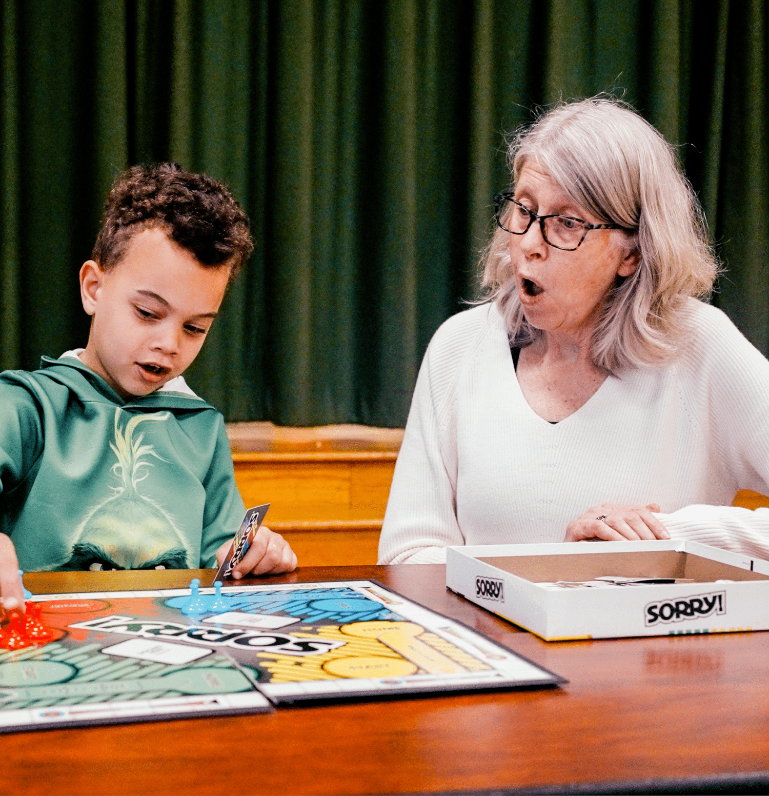 woman and boy playing board game