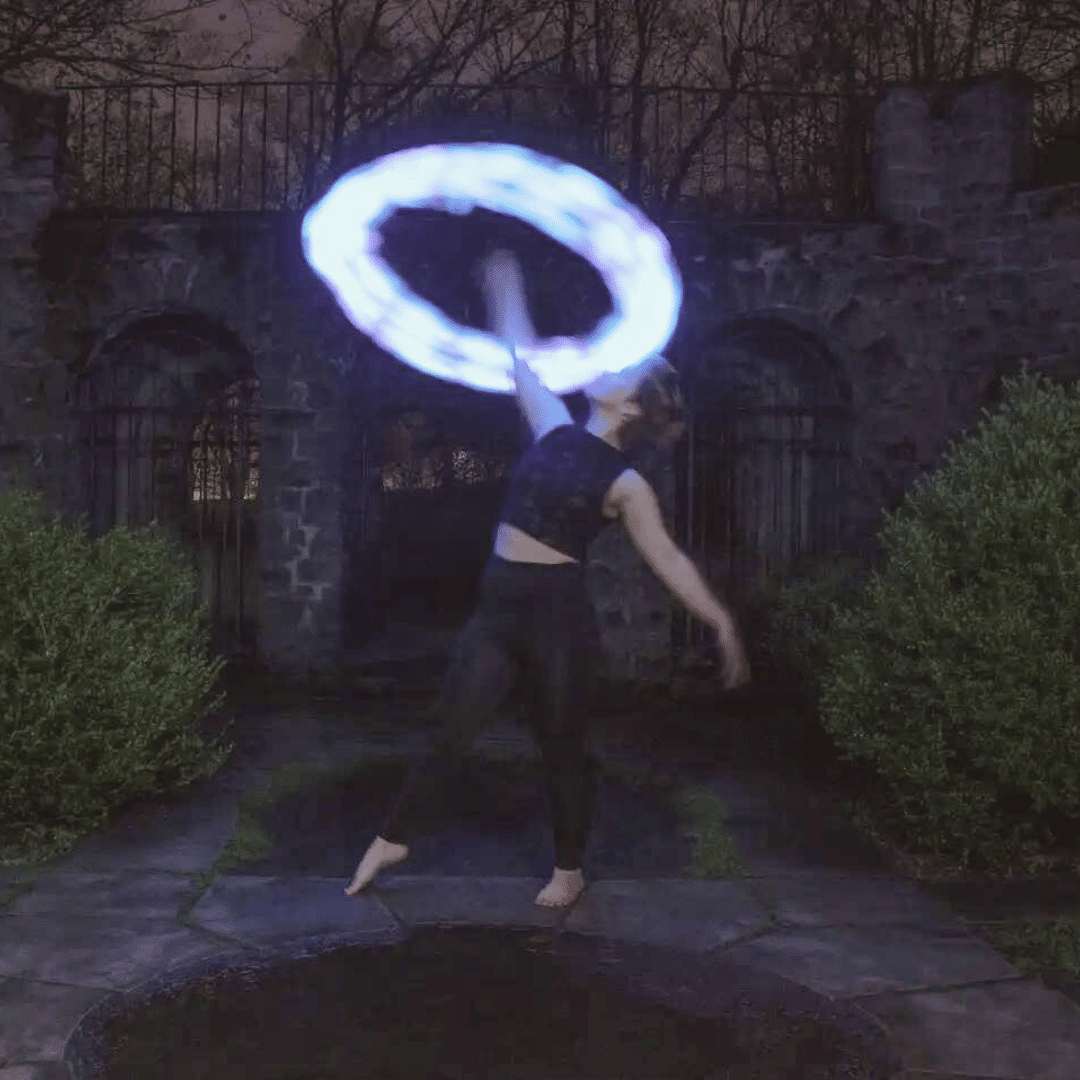 Woman Spinning Blue Light-Up Sock Poi above her head