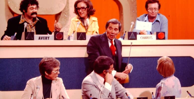 Six celebrities on set with orange and blue background