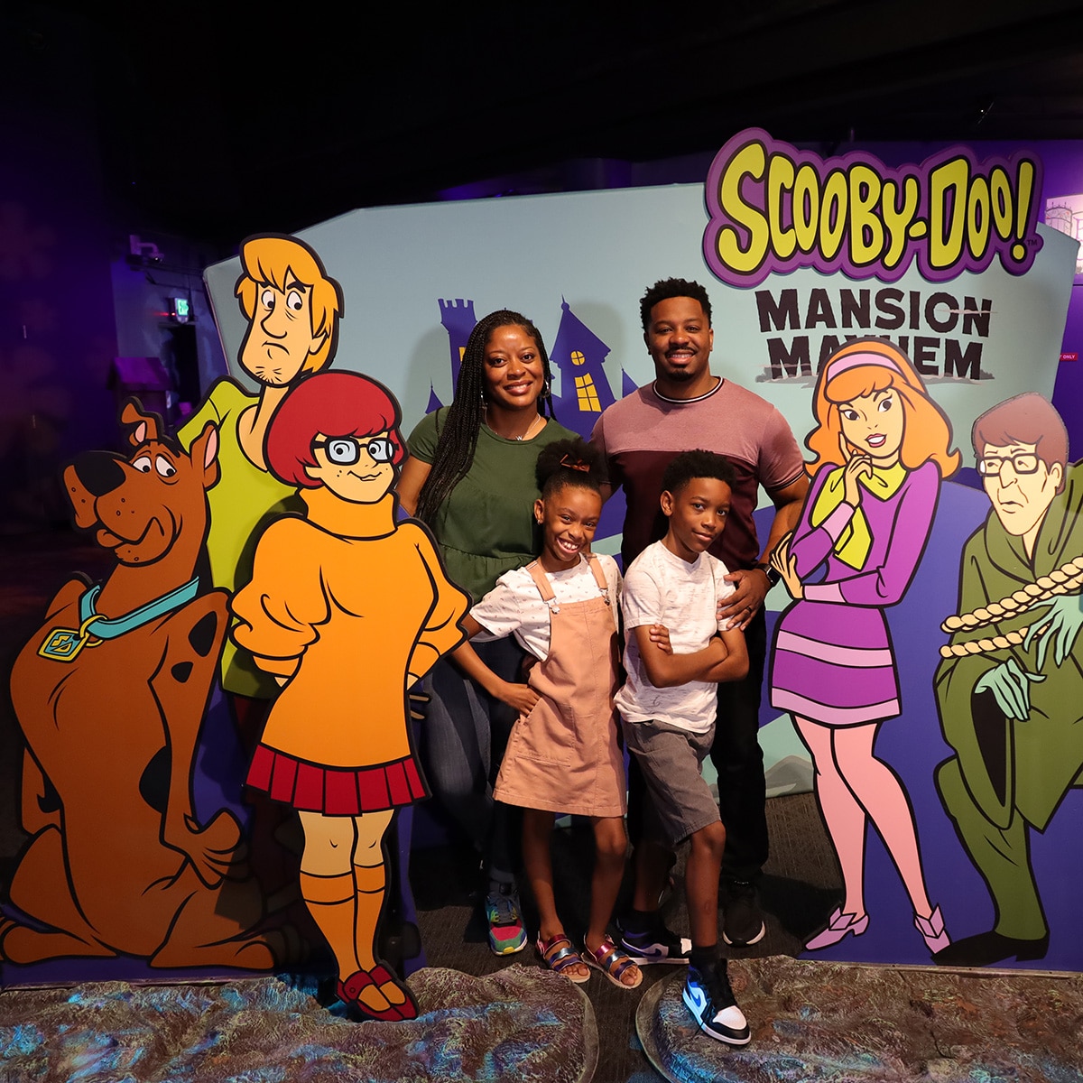 Scooby Doo exhibit title wall with family