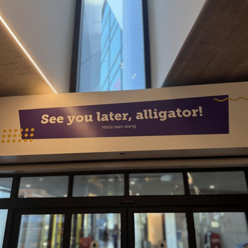 Sign above the exit that reads, "See you later, alligator."
