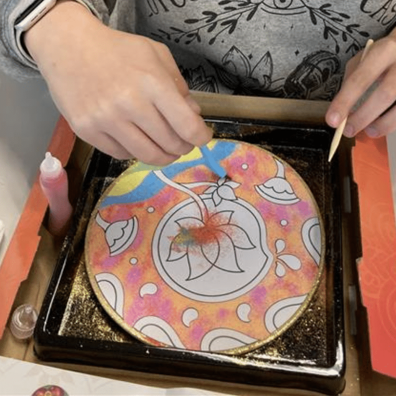 Person creating Rangoli Mandala Sand Art