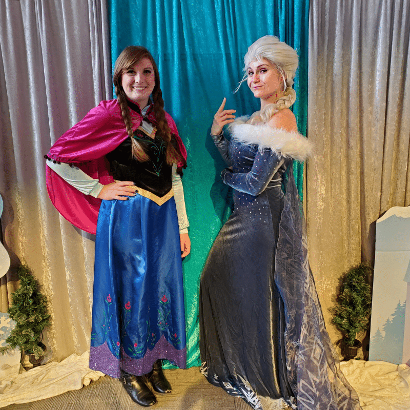 ELSA and ANNA costume characters posing for a photo