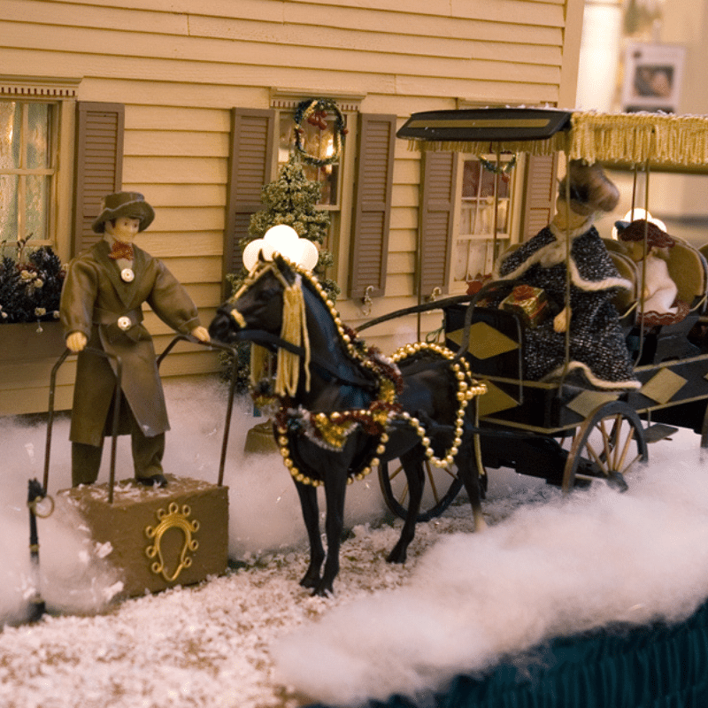 Figures of a man and a horse carriage with the Miller Manor doll house