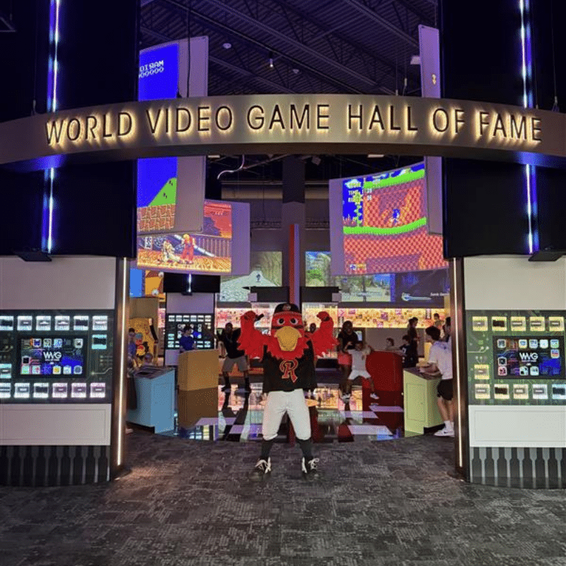 Red Wings mascot, Spikes, posing in the World Video Game Hall of Fame