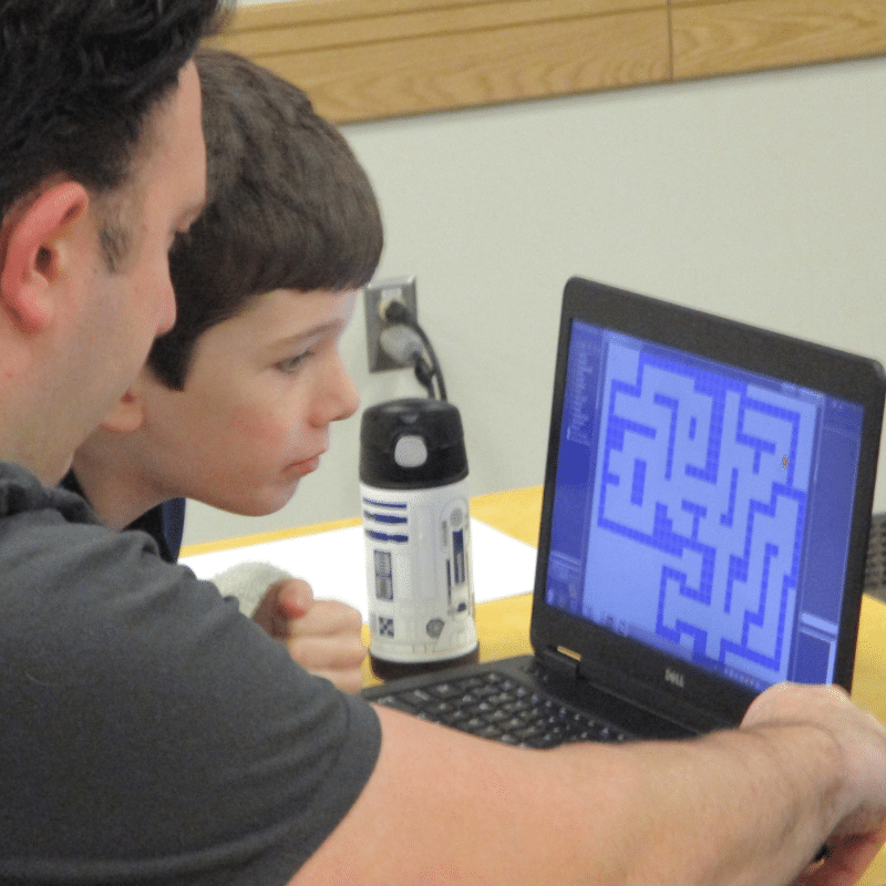 Boy sitting at his computer getting help on his game