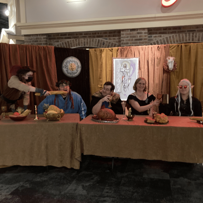 People in medieval outfits sitting around a table
