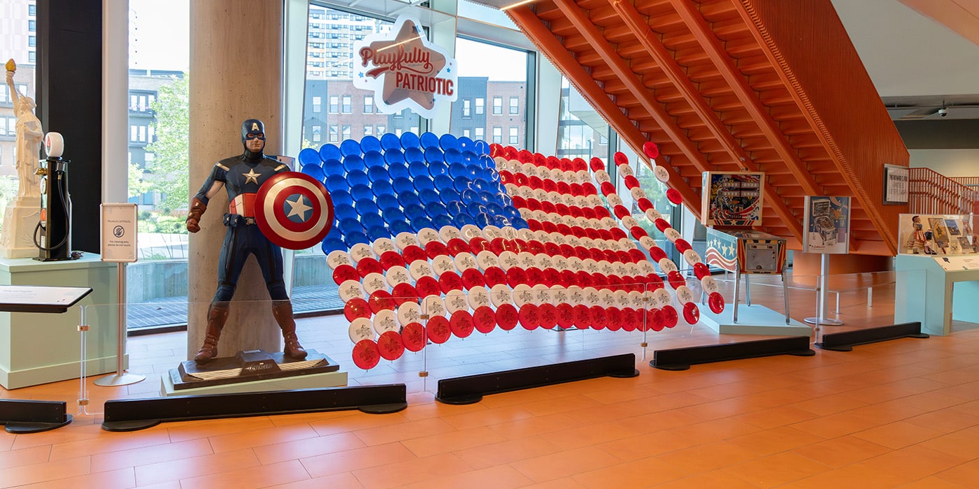 Playfully Patriotic display with frisbee flag and captain America statue