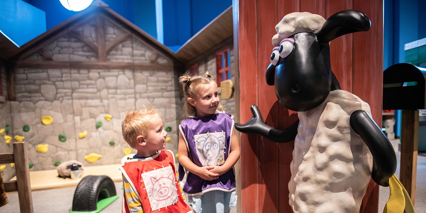 Two children with Shaun the Sheep figure