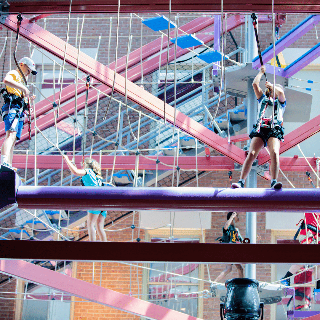 Girl climbing on high ropes course