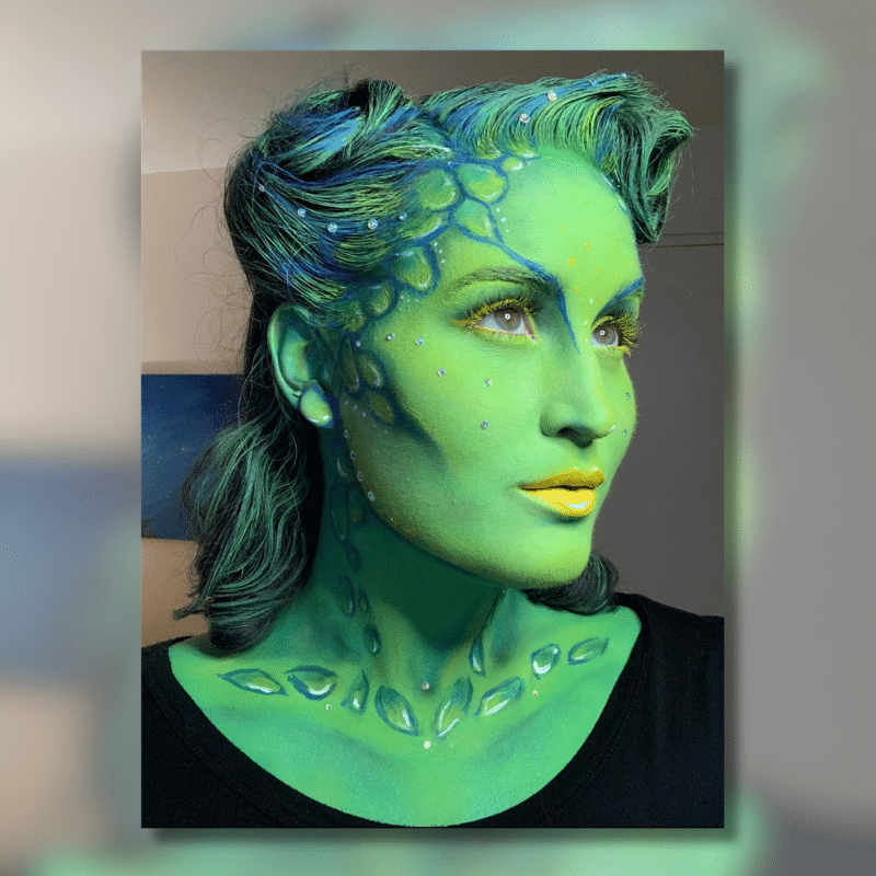 Woman with face painted green
